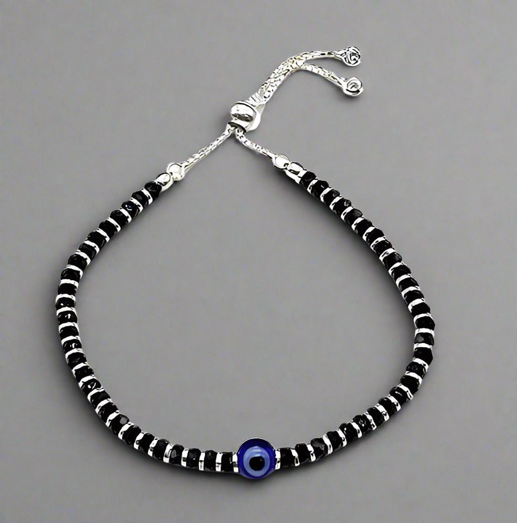 A beautiful 925 sterling silver black thread anklet featuring a combination of black and silver beads along with an elegant evil eye charm. This adjustable anklet is designed for both girls and women, offering style and comfort. Ideal for daily wear or special occasions, the anklet has a modern yet traditional appeal with its sleek design, protective evil eye charm, and sterling silver beads that add a touch of elegance.