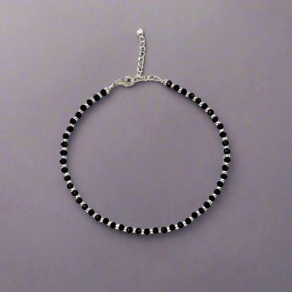 925 Sterling Silver Nazariya Anklet with elegant Black & Silver Crystal Beads, designed for girls and women. This adjustable anklet is comfortable, stylish, and perfect for everyday wear or special occasions. Made with high-quality sterling silver, the anklet is a beautiful combination of tradition and modern fashion, ideal for adding a unique touch to your jewelry collection. A great gift idea for loved ones, designed to suit all occasions, from casual outings to festive celebrations.