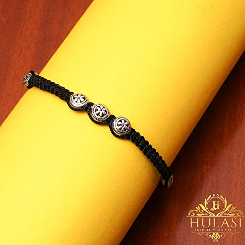 An elegant 925 sterling silver black thread anklet featuring five intricately designed round flower beads and two shiny silver balls. This stylish anklet is adjustable, making it perfect for girls and women of all sizes. Its lightweight and comfortable design make it an ideal accessory for casual and special occasions. The high-quality sterling silver elements give it a refined and polished look, making it a beautiful choice for those who appreciate timeless jewelry.